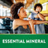 Young woman stretching in a gym, with a green banner at the bottom displaying 'ESSENTIAL MINERAL'.