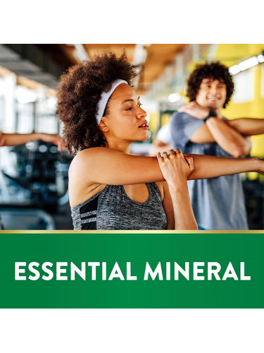 Young woman stretching in a gym, with a green banner at the bottom displaying 'ESSENTIAL MINERAL'.
