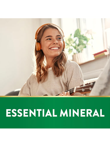 Young woman smiling, wearing headphones, holding a ukulele, with 'ESSENTIAL MINERAL' text on a green banner.