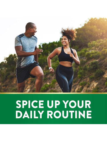 Smiling man and woman jogging outdoors, holding a bottle of Turmeric.