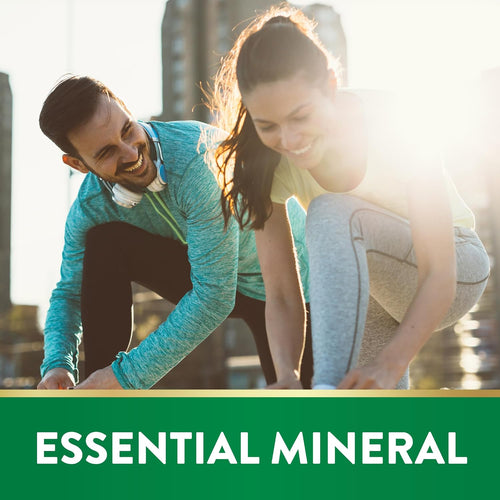 Young man and woman smiling as they tie their shoes under a banner that reads 'ESSENTIAL MINERAL'.