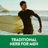 Young adult Black man in wetsuit, smiling with a surfboard on the beach. Text reads 'TRADITIONAL HERB FOR MEN'.