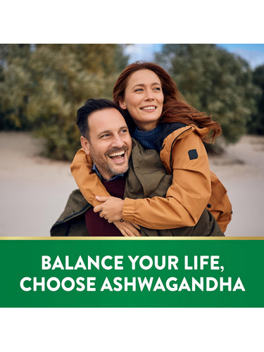 Smiling adult couple enjoying a piggyback ride outdoors. Text overlay reads: 'BALANCE YOUR LIFE, CHOOSE ASHWAGANDHA'.