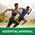 A young adult woman and man sprinting outdoors under a banner that reads 'ESSENTIAL MINERAL'.