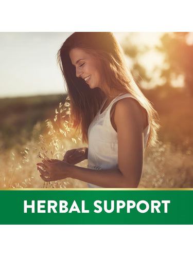 A young woman smiles while touching tall grasses in a sunlit field, symbolizing Rhodiola Rosea.