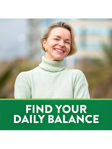 Smiling blonde woman in a light green turtleneck. Below her, a green banner reads 'FIND YOUR DAILY BALANCE'.