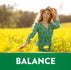 A woman smiles in a yellow flower field with 'BALANCE' text, featuring St. John's Wort.