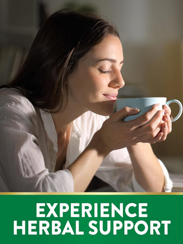 Young woman with eyes closed enjoys aromatic herbal drink from a mug, highlighting wellness benefits.