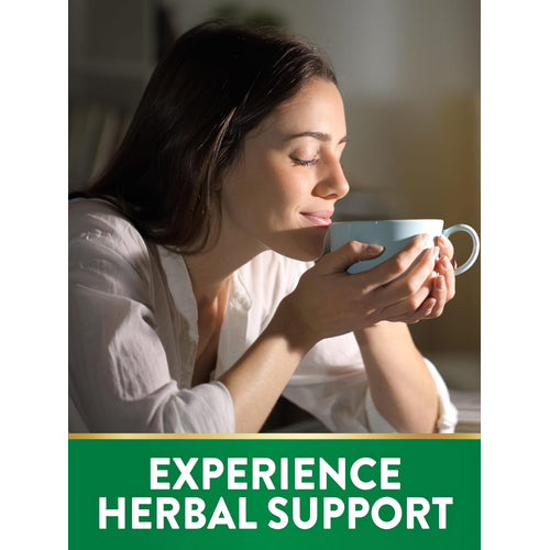 Young woman with eyes closed enjoys aromatic herbal drink from a mug, highlighting wellness benefits.