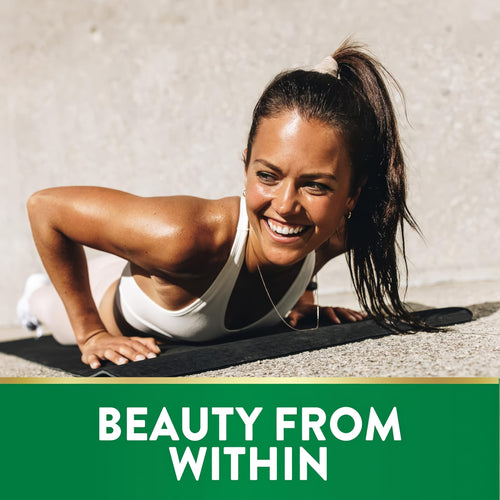 Young woman doing a push-up on a mat outdoors, smiling and sweaty, promoting Biotin.