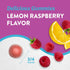 Lemon Raspberry magnesium gummy, 3/4 inches in size, next to fresh raspberries and lemon slices.