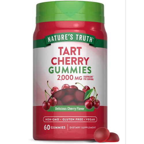 A hand holding a bottle of Tart Cherry 2,000 MG equivalent gummies, with a notable balance of supplements seen in the scale.