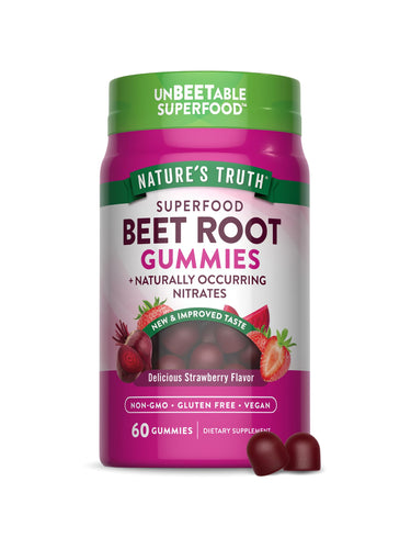 A hand holding two dark red beet root gummies, showcasing their size and color against a neutral background.