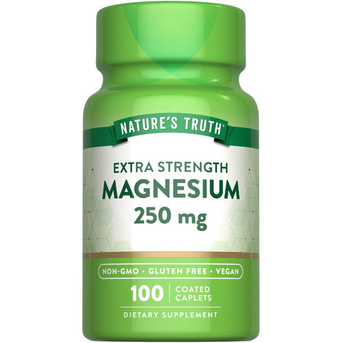 Hand holding bottle of 100 coated magnesium 250 mg caplets for daily supplement needs.