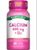 Bottle of Calcium 600 mg with Vitamin D3, containing 60 coated caplets, displayed on hand scale. Health supplement for bone support.