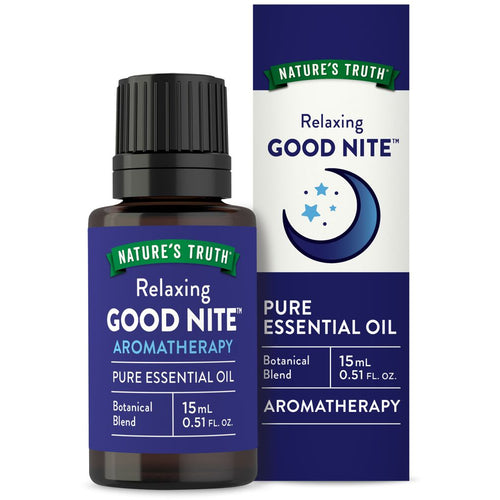 Hand holding a 15 mL NT Good Nite Oil essential oil bottle next to its packaging box.