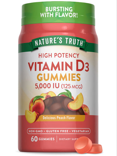Two orange Vitamin D3 gummies, providing 5,000 IU (125 mcg) each, rest on a bulk scale.