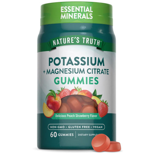 Two round, orange gummies of Potassium and Magnesium Citrate.