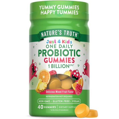 A close-up of two round yellow Kids Probiotic Gummies on a hand scale, indicating their size and shape for children.