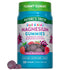Hand holding purple Just 4 Kidz Magnesium Gummies, featuring a delicious mixed berry flavor.