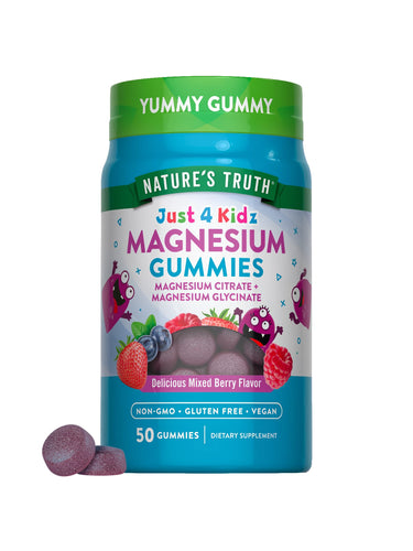 Hand holding purple Just 4 Kidz Magnesium Gummies, featuring a delicious mixed berry flavor.