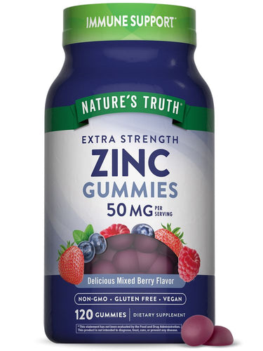 A hand holds two purple gummies on a gray background, highlighting the product's vibrant color and potential appeal to customers.