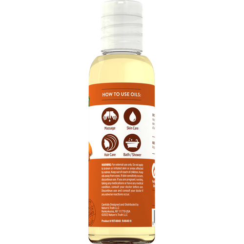 NT Sweet Almond Oil 4 oz bottle, back label showing usage instructions for massage, skin, hair, bath/shower, and safety warnings.