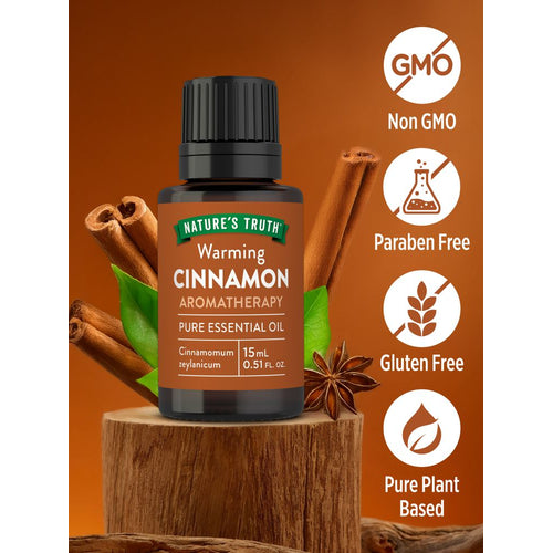 Bottle of cinnamon oil labeled as Non GMO, Paraben Free, Gluten Free, and Pure Plant Based.