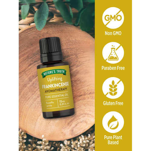 Frankincense Oil bottle, Non GMO, Paraben Free, Gluten Free, Pure, Plant Based displayed on a hand scale.