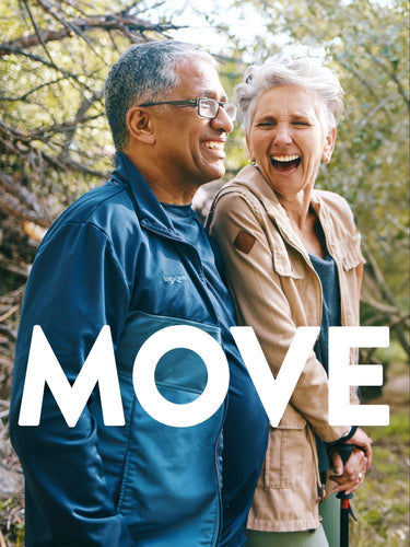 An older man and woman laugh outdoors, with the woman holding a trekking pole. Overlay text reads 'MOVE'.