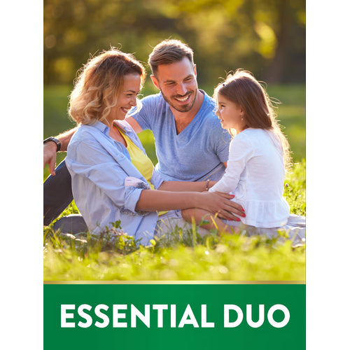 Family—man, woman, young girl—smiling while sitting on grass in park with text overlay: ESSENTIAL DUO.