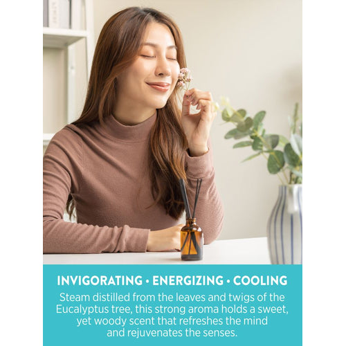 A young woman smells a flower beside a reed diffuser of NT Eucalyptus Oil. Graphic text: INVIGORATING, ENERGIZING, COOLING.