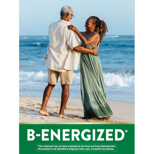 Elderly African American couple smiling and embracing on a beach with the text B-ENERGIZED.