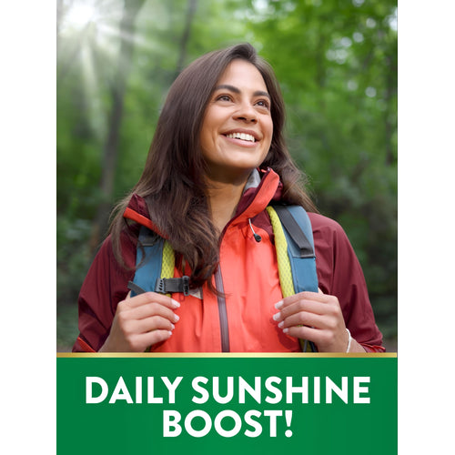 Young woman hiking in a forest, smiling towards the sun with a green graphic stating 'DAILY SUNSHINE BOOST!'