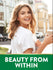 Smiling woman outdoors with laptop and coffee. Green banner with gold trim shows 'BEAUTY FROM WITHIN'.