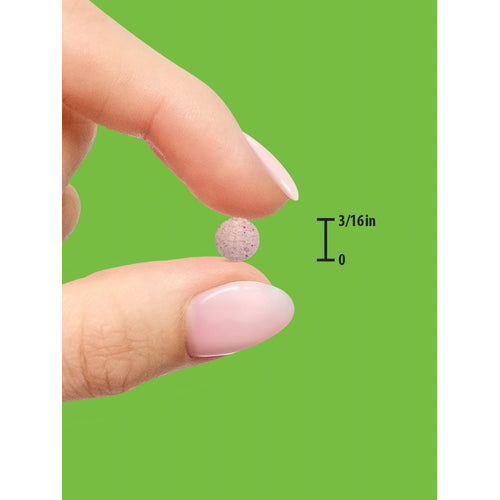 A small speckled round tablet is held between two fingers, measuring 3/16 inch in size.