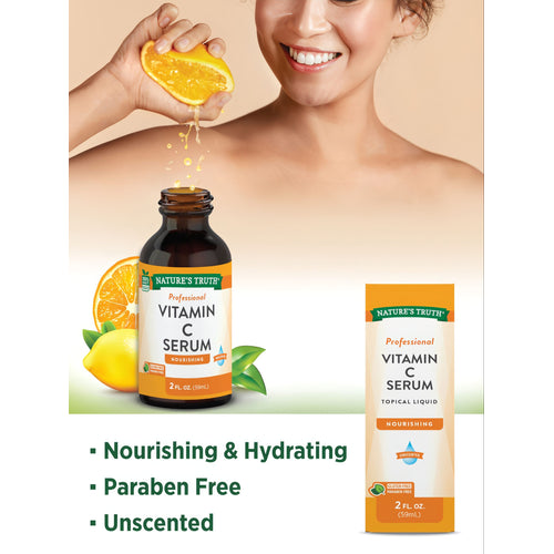 A woman squeezes a fresh orange over a professional Vitamin C Serum bottle (2 fl oz, 59mL).