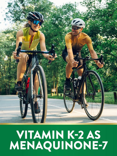 Man and woman cycling on a paved path; graphic text reads 'VITAMIN K-2 AS MENAQUINONE-7'.