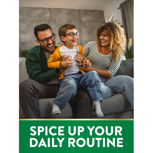 A family with a man, woman, and young boy is joyfully laughing and playing together on a sofa at home.