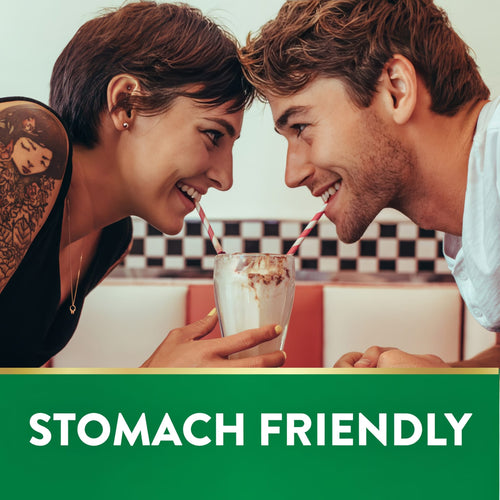 Young man and woman share a milkshake in a diner. Green banner reads 'STOMACH FRIENDLY'.