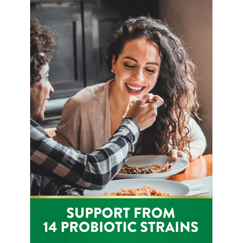 Smiling young man feeds young woman pasta. Green banner reads 'SUPPORT FROM 14 PROBIOTIC STRAINS'.