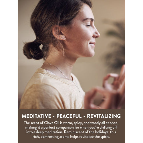 Young woman meditating with eyes closed and hands in mudra pose, accompanied by Clove Oil.