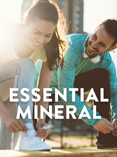 Young adult woman and man tying shoelaces outdoors, smiling, with graphic text 'ESSENTIAL MINERAL' and Magnesium Citrate.