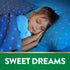 Young boy sleeping in bed under a blue starry blanket and pillow with a green banner reading 'SWEET DREAMS'.