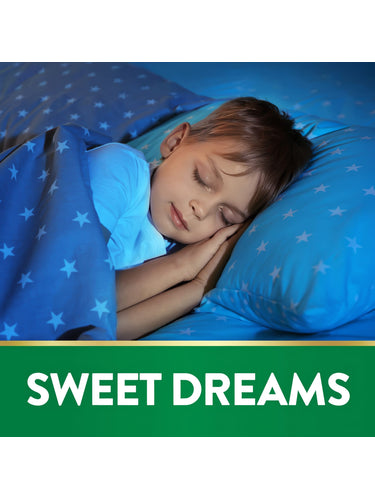 Young boy sleeping in bed under a blue starry blanket and pillow with a green banner reading 'SWEET DREAMS'.