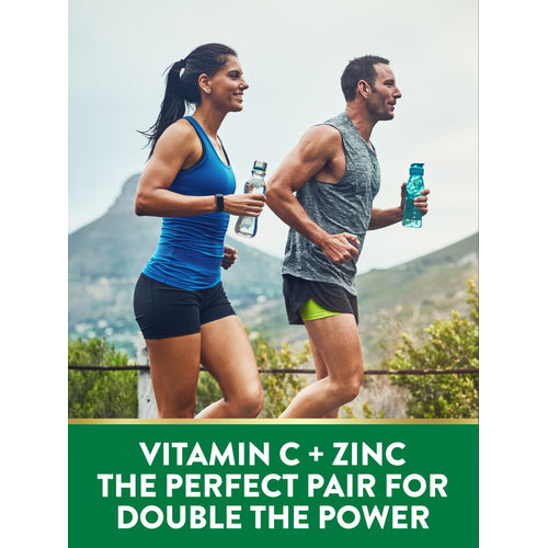 A man and woman running outdoors, each holding a water bottle. Green banner reads: 'VITAMIN C + ZINC THE PERFECT PAIR FOR DOUBLE THE POWER'.