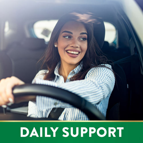 A young woman drives a car holding a product with Lutein and Zeaxanthin.