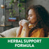 Young woman relaxing with a cup. Graphic text reads 'HERBAL SUPPORT FORMULA'.