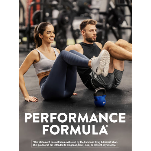 Young adult woman and man exercising in a gym, sitting on the floor, with a blue kettlebell nearby.