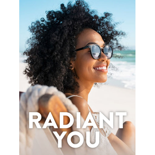 Young adult woman smiling on a beach, wearing sunglasses, looking towards the ocean. Text overlay: 'RADIANT YOU'.